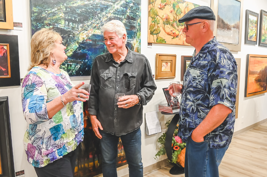 Photo of three people in an art gallery